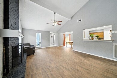 Living room is open to the dining area, kitchen and connects to a half bath and the primary bedroom