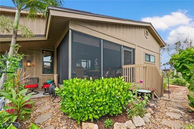 View of side of property with a patio and a sunroo