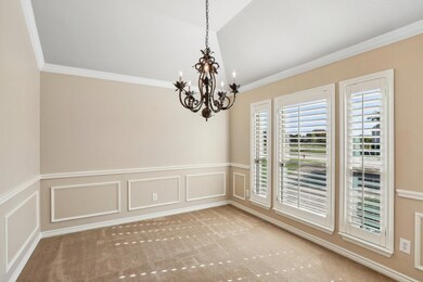 Carpeted empty room with ornamental molding and an