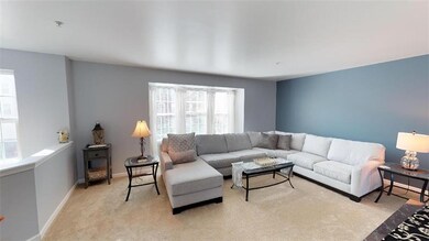 Large open living room with bay window and new car