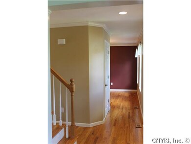 Foyer. Hardwood floors, an Oak staircase and crown