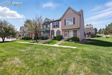 Townhome / multi-family property featuring board and batten siding, a front yard, a chimney, and a residential view