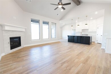 Unfurnished living room with high vaulted ceiling,