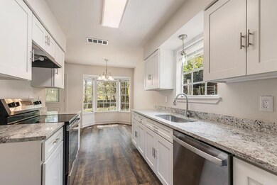 Kitchen with under cabinet range hood, a sink, vis
