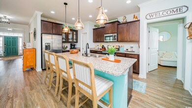 Kitchen with light wood finished floors, a sink, s