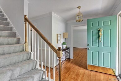 The foyer features hardwood floor, chair rail and