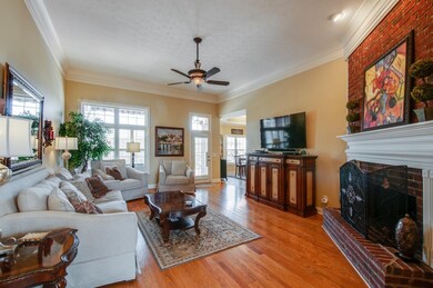 Relaxing Living Room - Gas Log Fireplace, Raised Hearth with Custom Moldings and Brick Hearth. Soaring Ceilings, Rich Hardwood floor, Ceiling Fan Light pours in from the windows. Great Space to entertain Family and Friends.