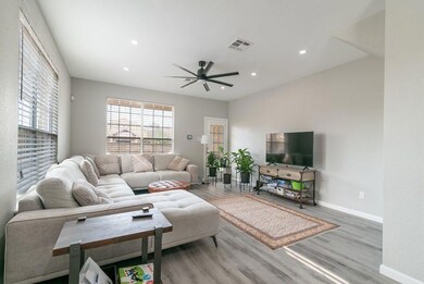 Living area featuring ceiling fan, recessed light