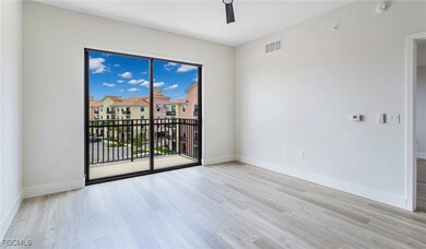 Spare room with wood finished floors, baseboards, a ceiling fan, and visible vents