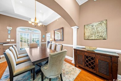 Dining area with decorative columns, crown molding