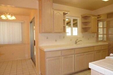 view of open kitchen to dining room with sliding d