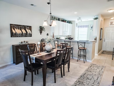 Dining area with light colored carpet
