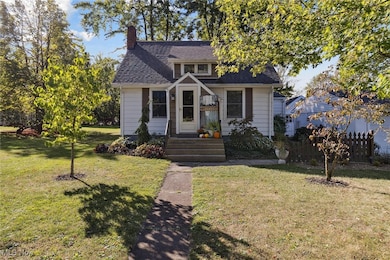 Bungalow-style home with a chimney and a shingled roof
