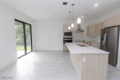 Kitchen with visible vents, modern cabinets, stain