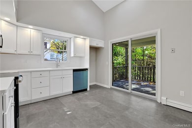 Kitchen featuring white cabinetry, dishwasher, sink, and a baseboard heating unit