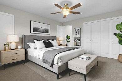 Bedroom with dark carpet, a ceiling fan, and a closet