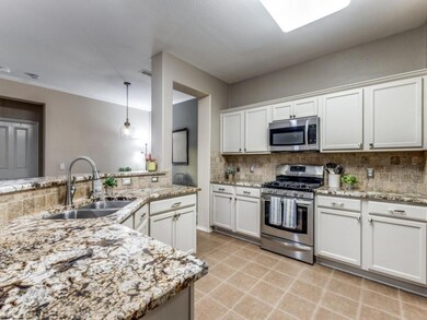 Kitchen with backsplash, appliances with stainless