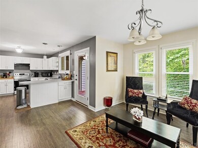 Family Room off of Kitchen. Can be used for dining area or as a family room. LVT Floors, chandelier and leads to back deck.