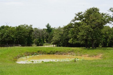 View of yard featuring fence and a wooded view