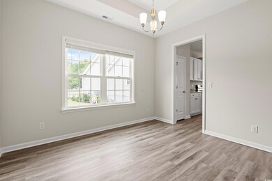 Empty room with a chandelier, light wood-style floors, and baseboards