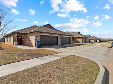 View of front of house with brick siding, driveway