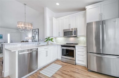 Kitchen with white cabinets, stainless steel appli