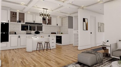 Kitchen featuring backsplash, white cabinets, a kitchen island, light wood-style flooring, and a kitchen breakfast bar