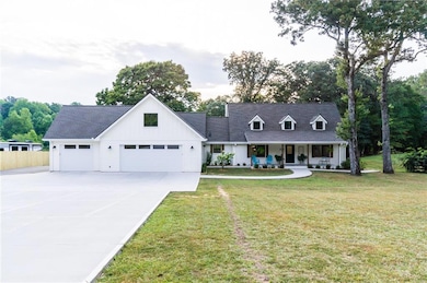 View of front of house with a front lawn, covered 