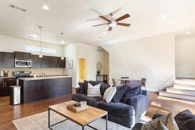Living area open to kitchen and dining area.