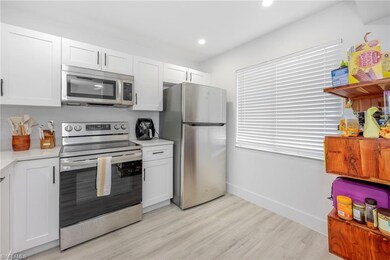 Kitchen featuring light countertops, light wood-ty