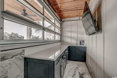 Bar area with light marble finish floors and wood ceiling