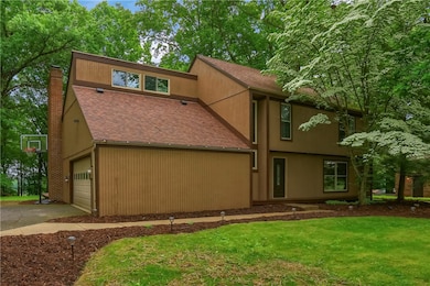 Nestled within mature trees is this charming home.