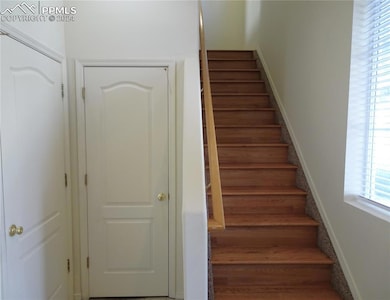 Staircase to the upper main level living with wood
