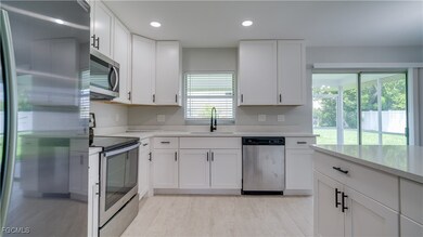 Kitchen featuring stainless steel appliances, white cabinets, healthy amount of natural light, and recessed lighting