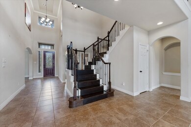 Step into elegance! This grand tiled entryway welc