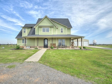 View of front of property featuring a porch, a gar