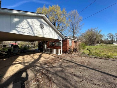 View of side of home with covered porch, brick sid
