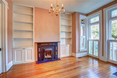 Front room with built-in cabinets and bookshelves
