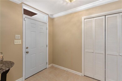 Tiled foyer with closet