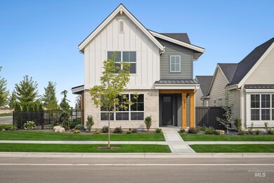 View of front facade featuring board and batten siding and brick siding