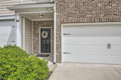 Property entrance with brick siding and concrete d