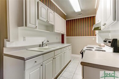 Kitchen offers tile flooring, neutral counter tops