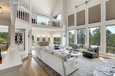 Living room featuring high vaulted ceiling, wood-t