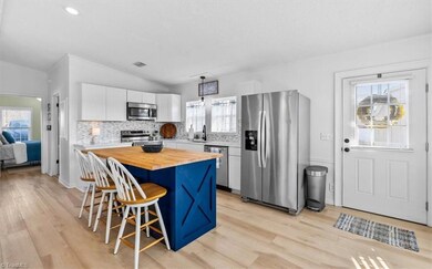 Cheery updated kitchen features stainless appliances.