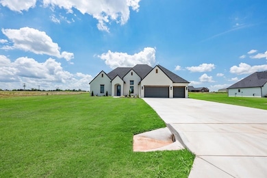 View of front facade with concrete driveway, an attached garage, and a front lawn