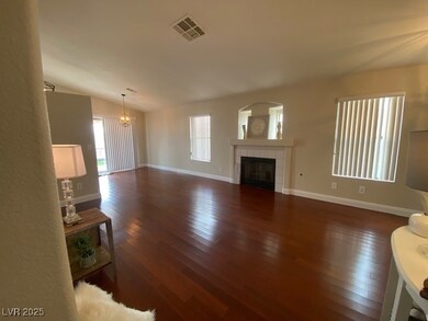 Living room featuring a cozy fireplace, wood floor
