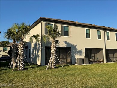 Back of property with central AC unit, a lawn, and