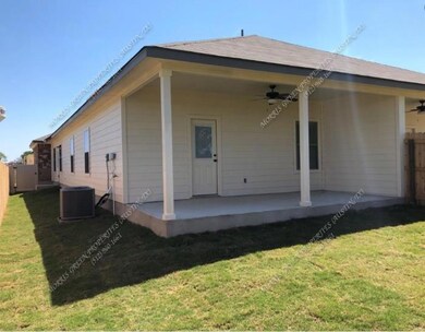 Rear view of house featuring ceiling fan and a patio
