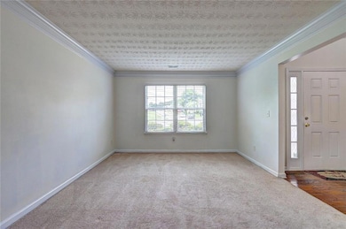 Foyer entrance with carpet flooring, baseboards, a