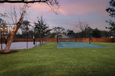 View of sport court featuring a tennis court